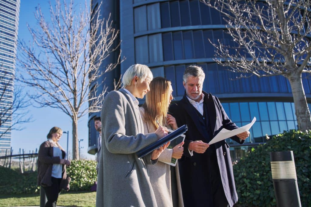 three business colleagues discussing matter outside office