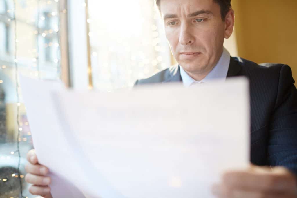 Business owner reading concerning letter