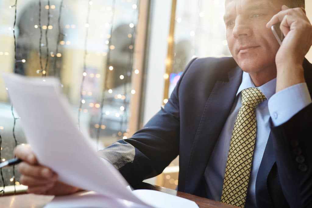 professional reading letter while on the phone